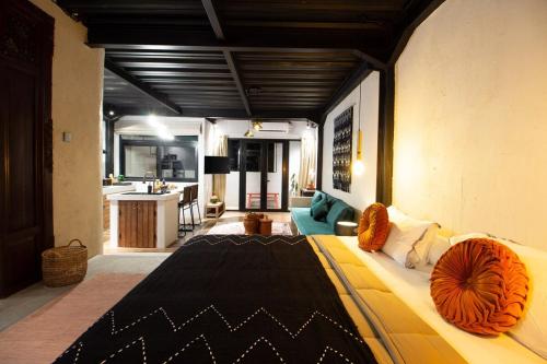 a living room with a large bed and a kitchen at Warehouse Loft - Chic industrial aesthetic loft in Dalung