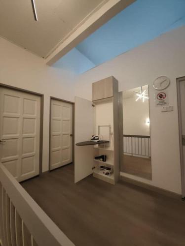 a room with a hallway with two doors and a counter at I-homey Residence 1 in Gua Sai