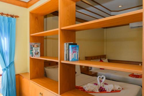 a bedroom with wooden shelves and a bunk bed at Dream Team Beach Resort in Ko Lanta