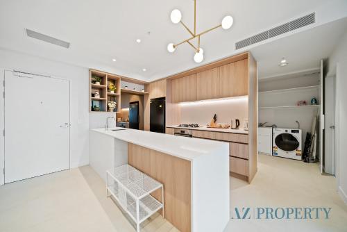 a kitchen with a white counter top in a room at Luxury Perth CBD Apartment with Pool & Gym - Sleeps 3 in Perth
