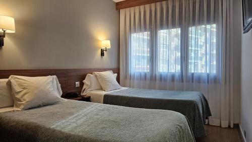 Ліжко або ліжка в номері Hotel Les 7 Claus