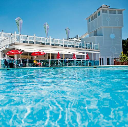 a pool of water in front of a building at Rockley Park, Poole, Stunning Sea View, Close to Beach in Poole
