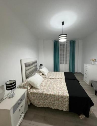 a bedroom with a bed and a dresser and a desk at El capricho de Olga in Almodóvar del Río