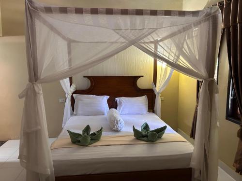 Postel nebo postele na pokoji v ubytování Leuser Inn & Jungle Trekking