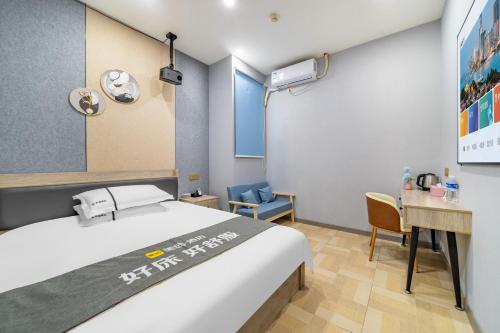 a bedroom with a bed and a desk and a table at Shanghai Grand View Hotel in Shanghai