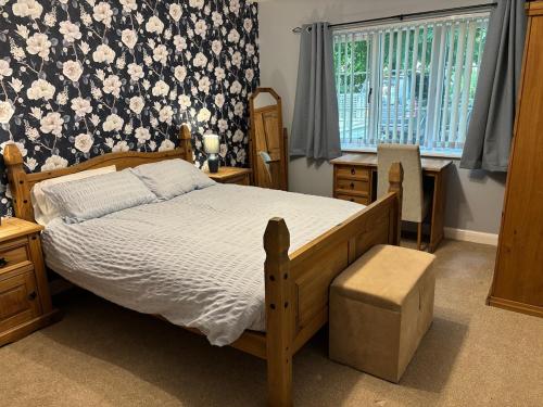 a bedroom with a wooden bed and a window at Birch View, Woodhall Spa in Woodhall Spa