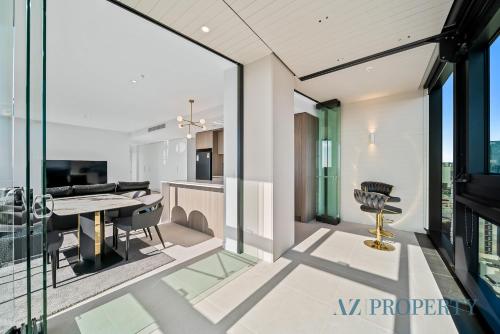 a kitchen and dining room with glass walls and a table at Bright & Spacious 2BR in Prime CBD Location in Perth