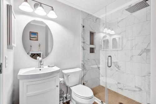 a white bathroom with a toilet and a shower at A145 HH Beach & Tennis Resort in Hilton Head Island