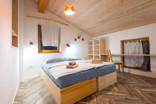 a bedroom with a bed with towels on it at Rest And Ride in Robidišče