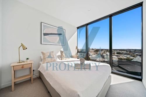 a bedroom with a bed and large glass windows at 1BR Apartment in the Heart of the CBD in Perth