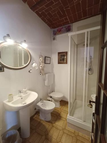 a bathroom with a sink and a toilet and a mirror at B&B da Stefy in Cuccaro Monferrato