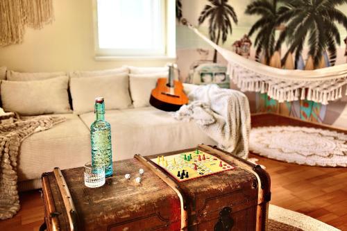 a living room with a table with a bottle on a trunk at Ganswoanders - deine kleine Beach Oase am Traunsee in Gmunden