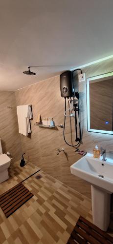 a bathroom with a camera on the wall and a sink at Badulla Bliss in Badulla