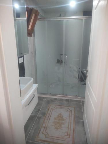 a bathroom with a shower and a toilet and a sink at Living House in Salihli