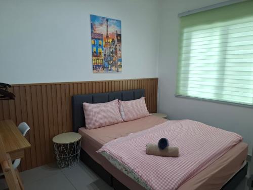 a bedroom with a bed with a bowl on it at Amber Cove - Luxury Design By Luxpro Management - 6~7 pax in Melaka