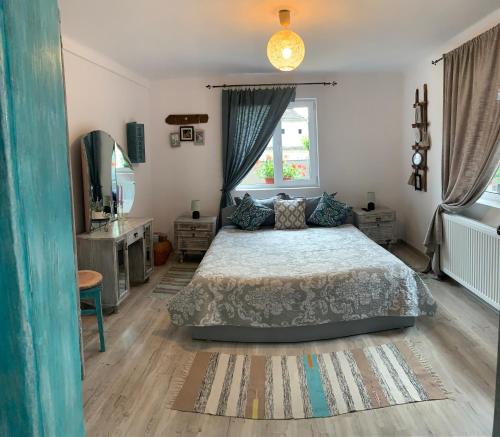 a bedroom with a bed and a window at Casa Santa in Sighişoara