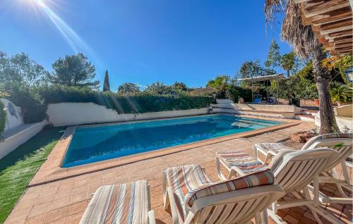 a swimming pool with two chairs and a swimming pool at Villa Avec Piscine 1 in Roquebrune-sur-Argens