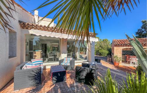 a patio of a house with chairs and tables at Villa Avec Piscine 1 in Roquebrune-sur-Argens