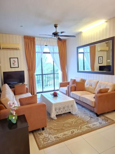 a living room with two couches and a table at Partial Seaview with Wifi, Batu Ferringhi in Batu Ferringhi