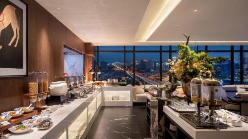 Una línea de buffet en un restaurante con vistas. en Chongqing Bert High-Altitude Hotel Jiangbeizui Financial Center Branch, en Chongqing