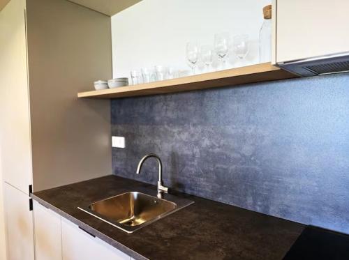 a kitchen with a sink and a counter top at Playa Sardinero - Little Homes 1-2-3-5 in Santander