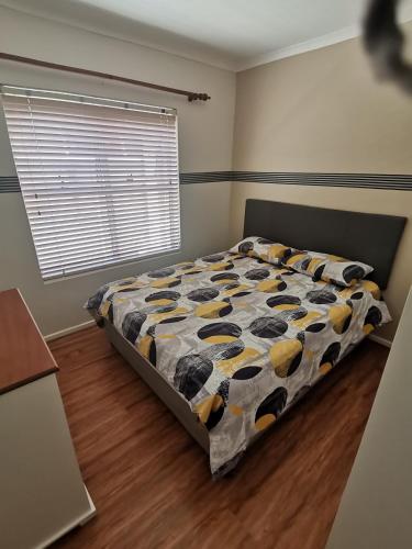 a bedroom with a bed with a cow blanket at Muize at Sea in Marina da Gama