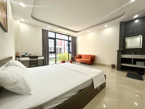 a large bedroom with a large bed and a chair at Ha Noi Smile Home in Ðình Loan