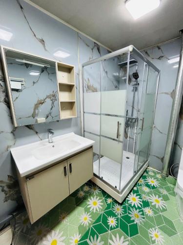 a bathroom with a sink and a shower at Mandakh Naran Guest House in Dzuunmod