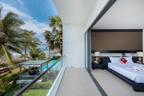 a bedroom with a balcony with a bed and a view at Villa D3 Private - In Great Location Front Of The Sea in Vung Tau