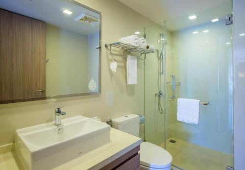 a bathroom with a sink and a toilet and a shower at Citadines Grand Central Sri Racha in Si Racha