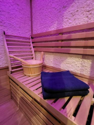a wooden bench with a blue bag sitting on it at Sauna, Terrasse, Fernblick & Design - modern-gemütliche FeWo am Aremberg in Aremberg