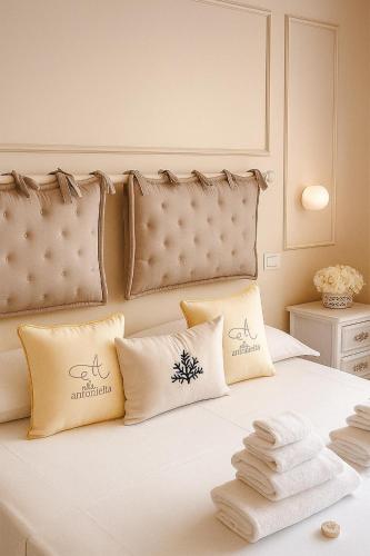 a bedroom with a bed with white sheets and pillows at Villa Antonietta Ischia in Forio d'Ischia