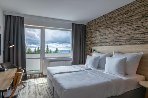 Ένα ή περισσότερα κρεβάτια σε δωμάτιο στο OREA Resort Horizont Šumava