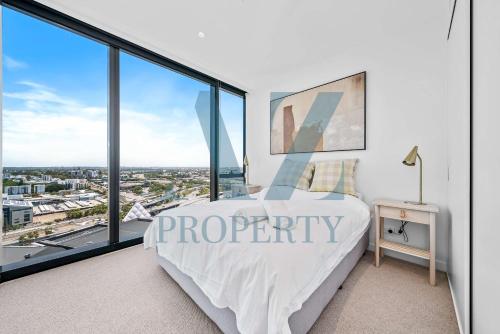 a bedroom with a view of a city at Brand new Luxurious 3 Bedroom Perth CBD in Perth