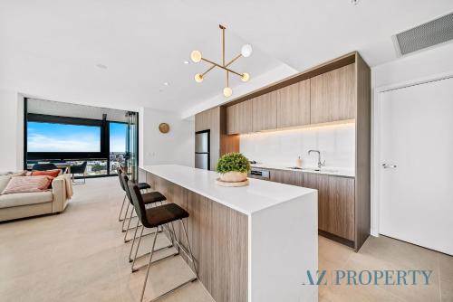 a kitchen and living room with a large island in a house at Brand new Luxurious 3 Bedroom Perth CBD in Perth