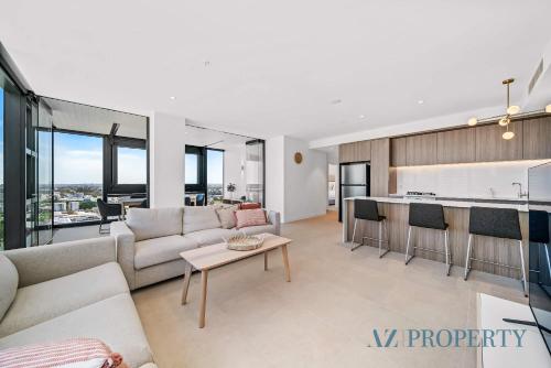 a living room with a couch and a table at Brand new Luxurious 3 Bedroom Perth CBD in Perth