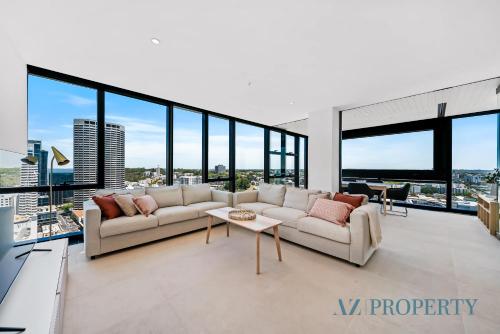 a living room with a couch and a table at Brand new Luxurious 3 Bedroom Perth CBD in Perth