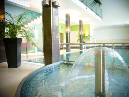 a glass bowl with water on a table in a building at Schweizerhof Ferienwohnungen Lenzerheide Haus 4 in Lenzerheide