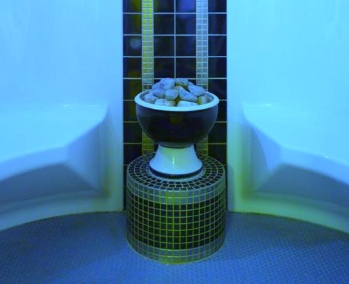 a bathroom with a bowl of rocks on a table at Hotel Schoch in Mainhardt