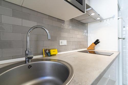 a kitchen with a sink and a counter top at rentafive - Nuevo - Centro - A/C in Santa Pola