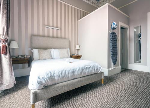 a bedroom with a large bed in a room at The Belhaven Hotel in Glasgow