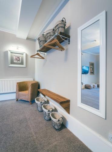 a room with a mirror and baskets on the wall at The Belhaven Hotel in Glasgow