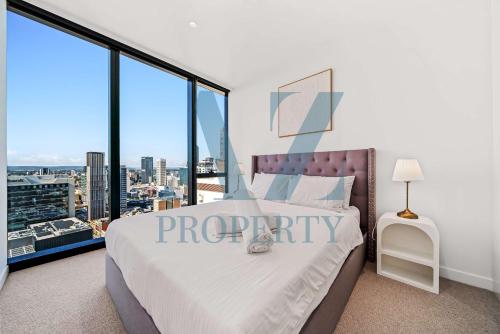 a bedroom with a large bed and large windows at Perth's Modern 1BR Apartment with Pool & Gym - City Living in Perth