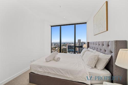 a bedroom with a bed and a large window at Perth's Modern 1BR Apartment with Pool & Gym - City Living in Perth