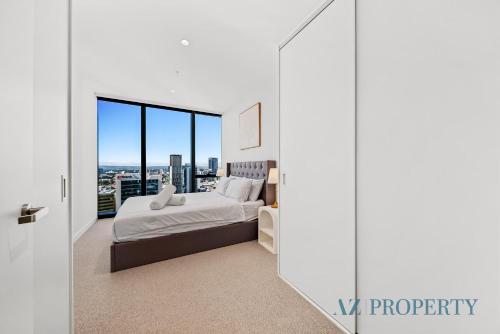 a white bedroom with a large bed and large windows at Perth's Modern 1BR Apartment with Pool & Gym - City Living in Perth