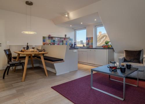 a kitchen and a living room with a table and a kitchen at Haus Svenja in Westerland (Sylt)