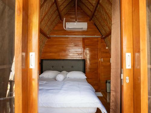 MantaakLumbung Lodge Lovina的一间木屋里有一张床的卧室