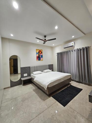 una camera da letto con un letto e un ventilatore a soffitto di Hotel Abhishek Pride - Shani Shinganapur a Godhegaon