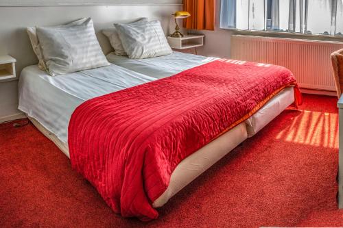 Ένα ή περισσότερα κρεβάτια σε δωμάτιο στο Hotel Hoogland Zandvoort aan Zee