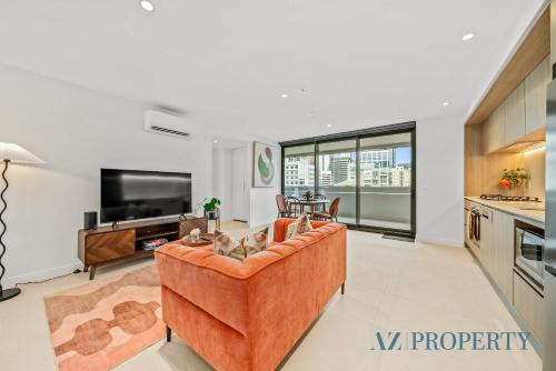 a living room with a couch and a tv at PerthViews Modern with Pool Gym in Perth